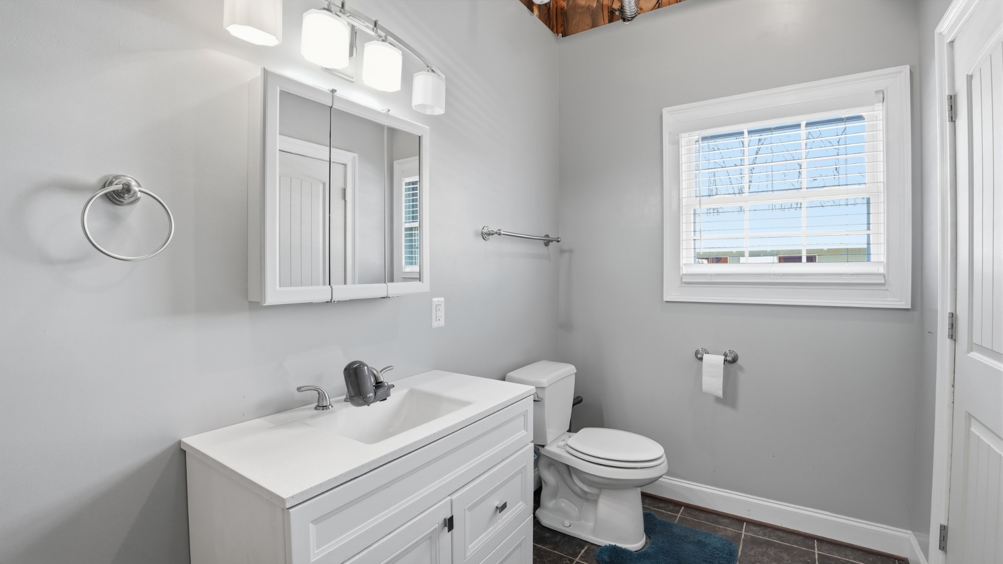 135 Vols Lane Estill Springs, TN 37330 - Photo 27 of 56 a bathroom with a toilet sink vanity and mirror