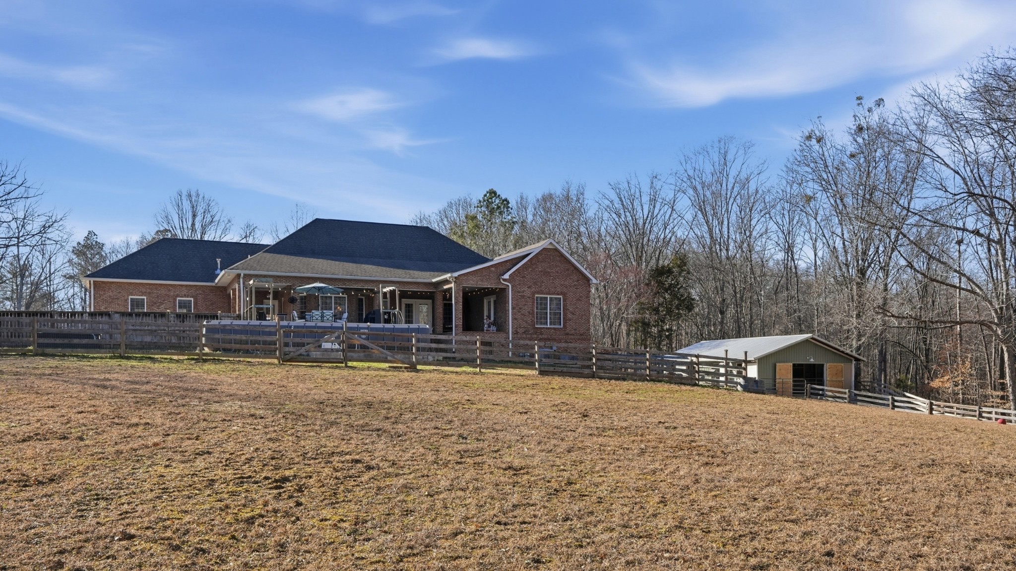135 Vols Lane Estill Springs, TN 37330 - Photo 45 of 56 a front view of a house with a yard covered with snow and trees