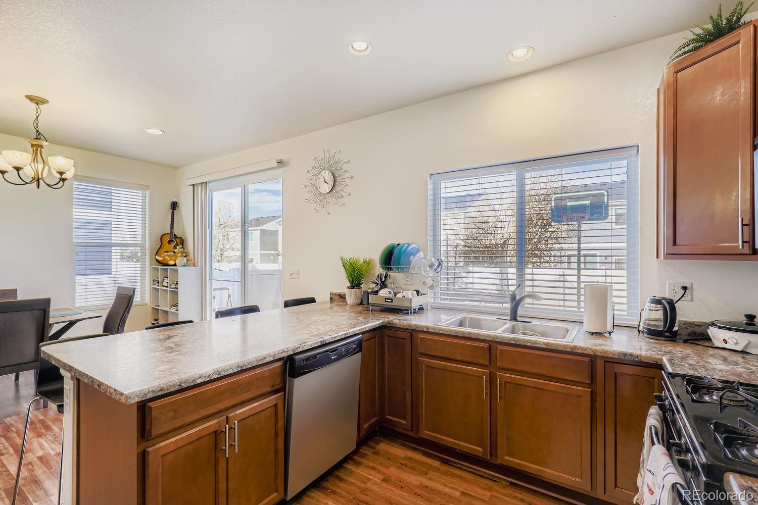 5545 Liverpool Street Denver, CO 80249 - Photo 11 of 28 a kitchen with a sink stove and cabinets