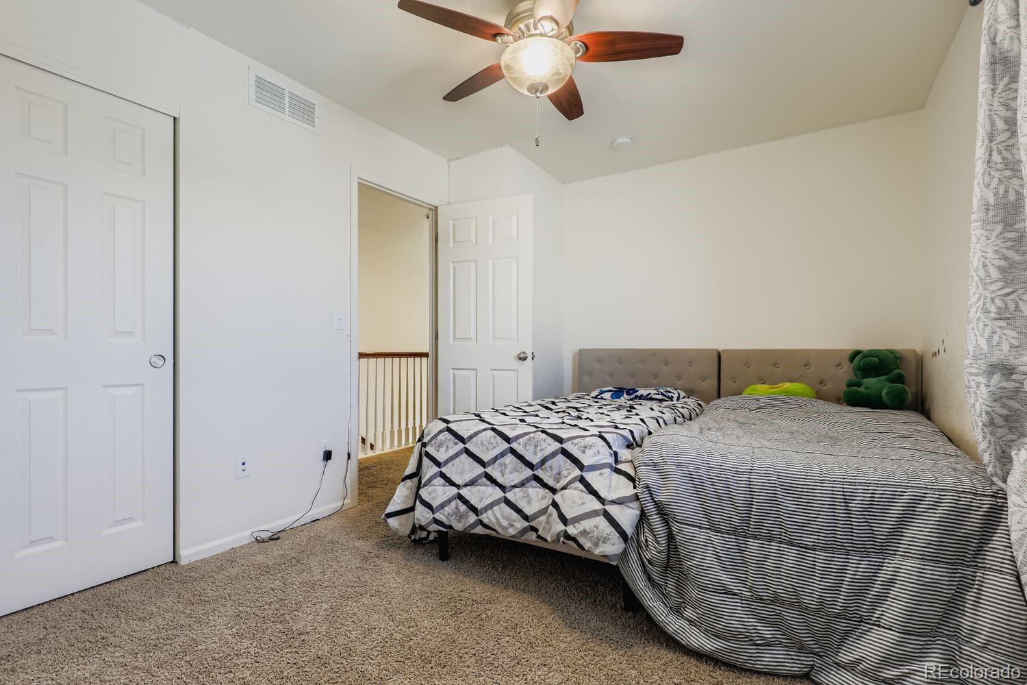 5545 Liverpool Street Denver, CO 80249 - Photo 20 of 28 a bedroom with a bed and window