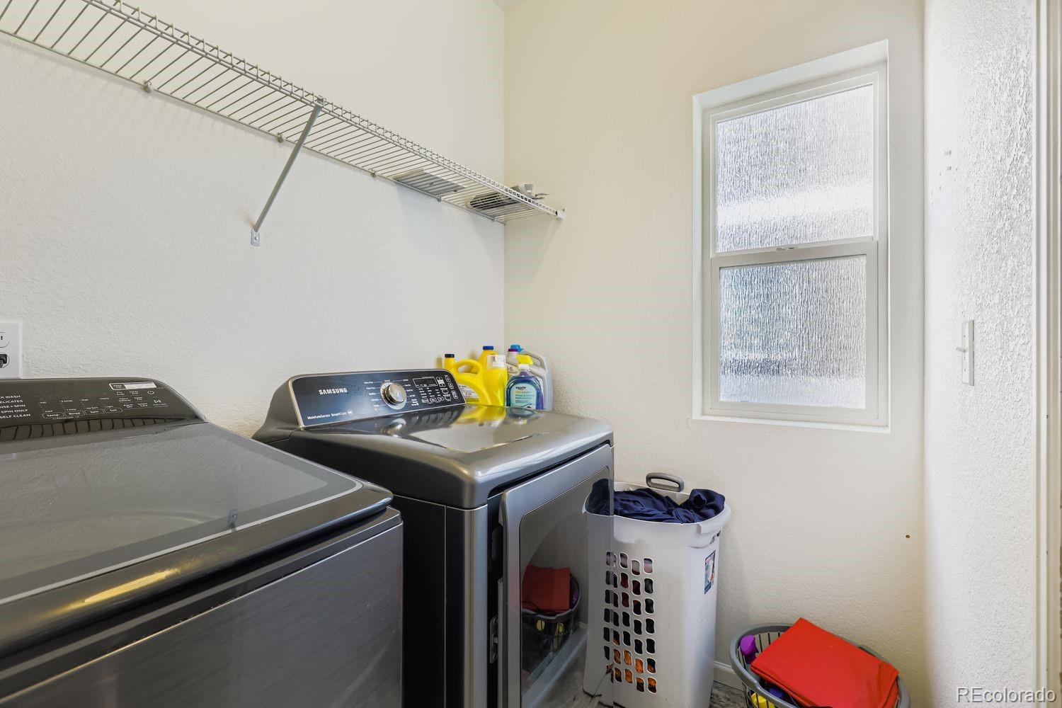 5545 Liverpool Street Denver, CO 80249 - Photo 25 of 28 a utility room with dryer and washer