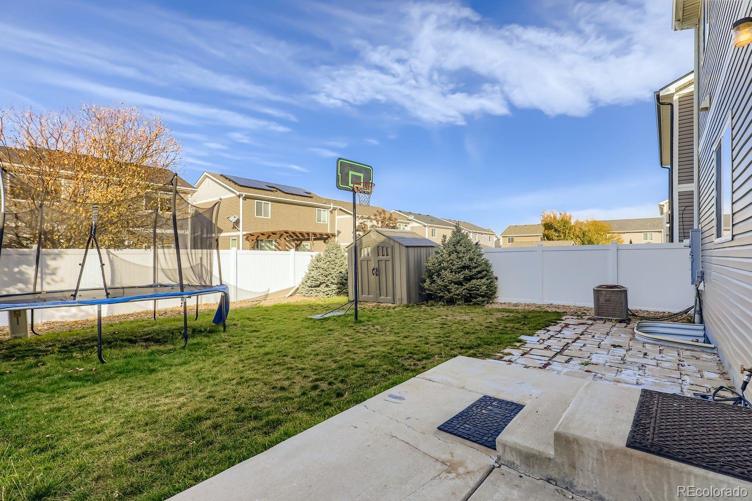 5545 Liverpool Street Denver, CO 80249 - Photo 26 of 28 a view of a backyard with a garden and plants
