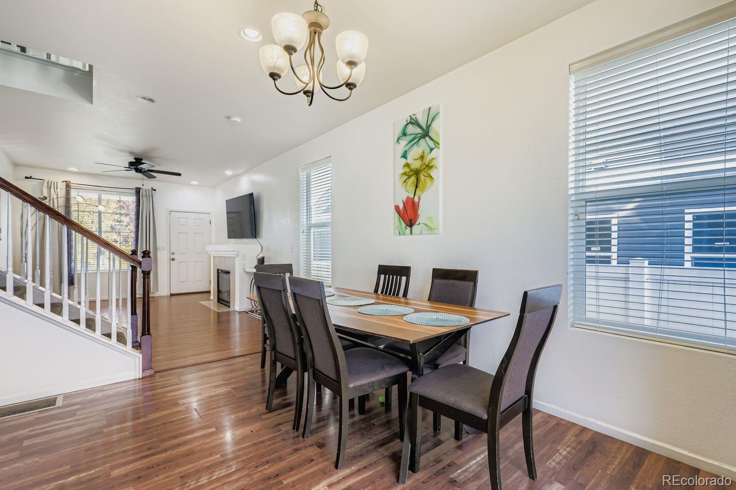 5545 Liverpool Street Denver, CO 80249 - Photo 7 of 28 a view of a dining room with furniture wooden floor and chandelier