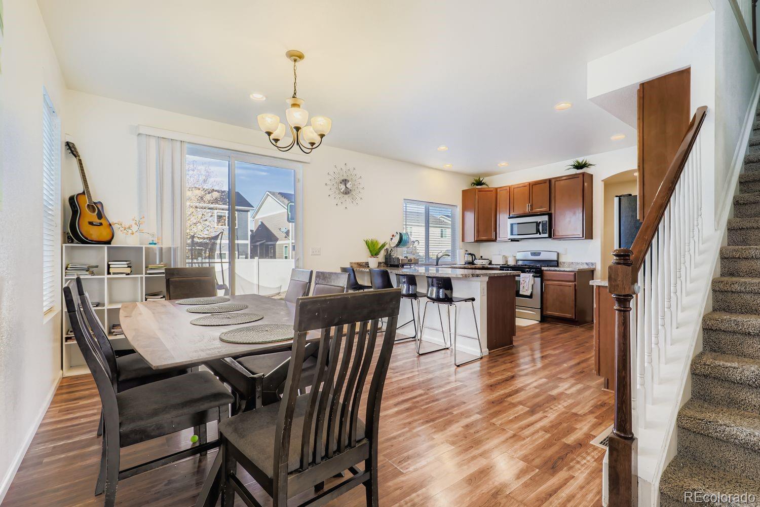 5545 Liverpool Street Denver, CO 80249 - Photo 9 of 28 a view of a dining room with furniture and wooden floor
