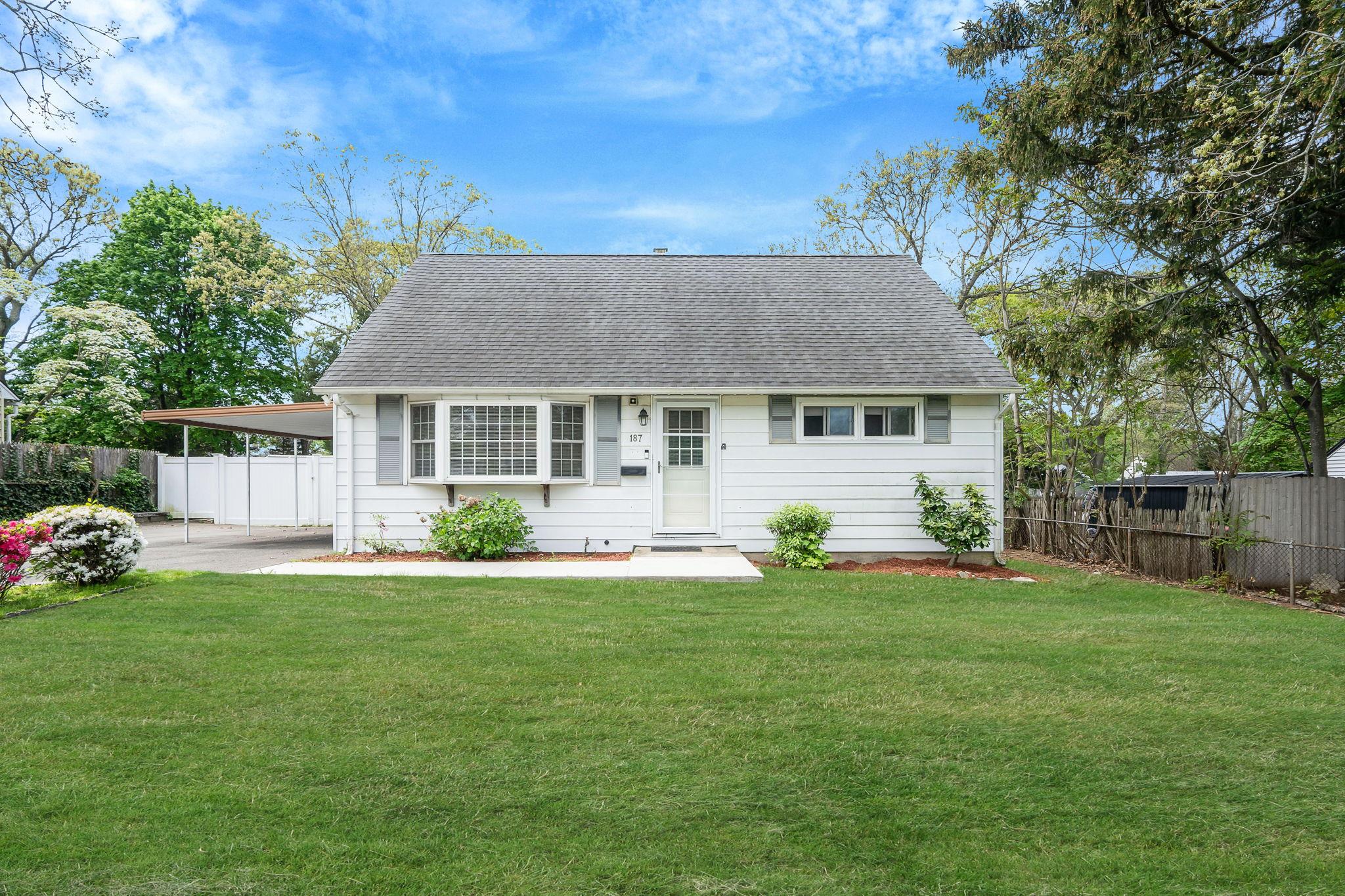 187 Mark Tree Road Centereach, NY 11720 - Photo 1 of 1 Cape cod house featuring roof with shingles and a carport