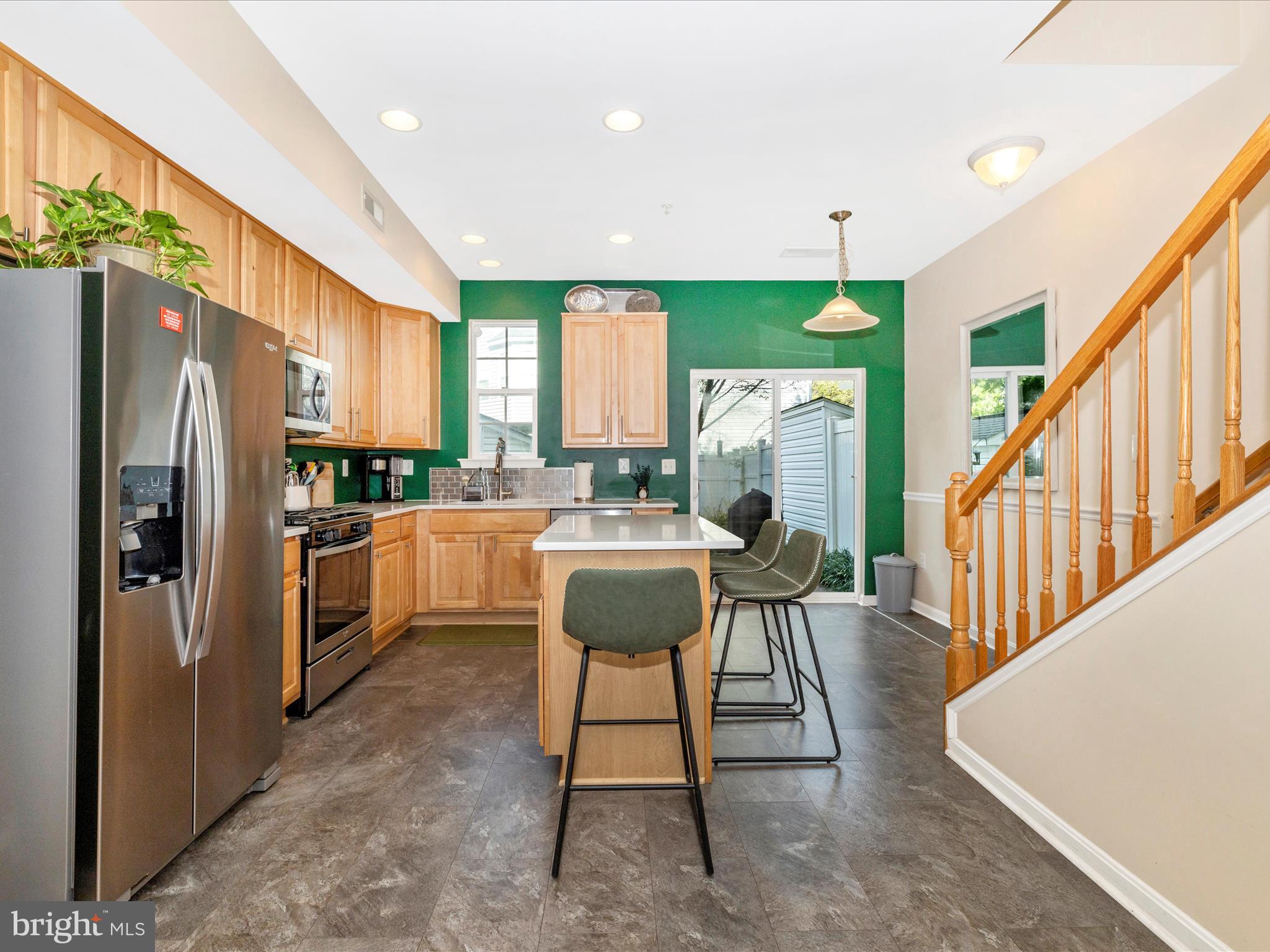 648 Tivoli Road Frederick, MD 21703 - Photo 14 of 51 a kitchen with a refrigerator a dining table and chairs
