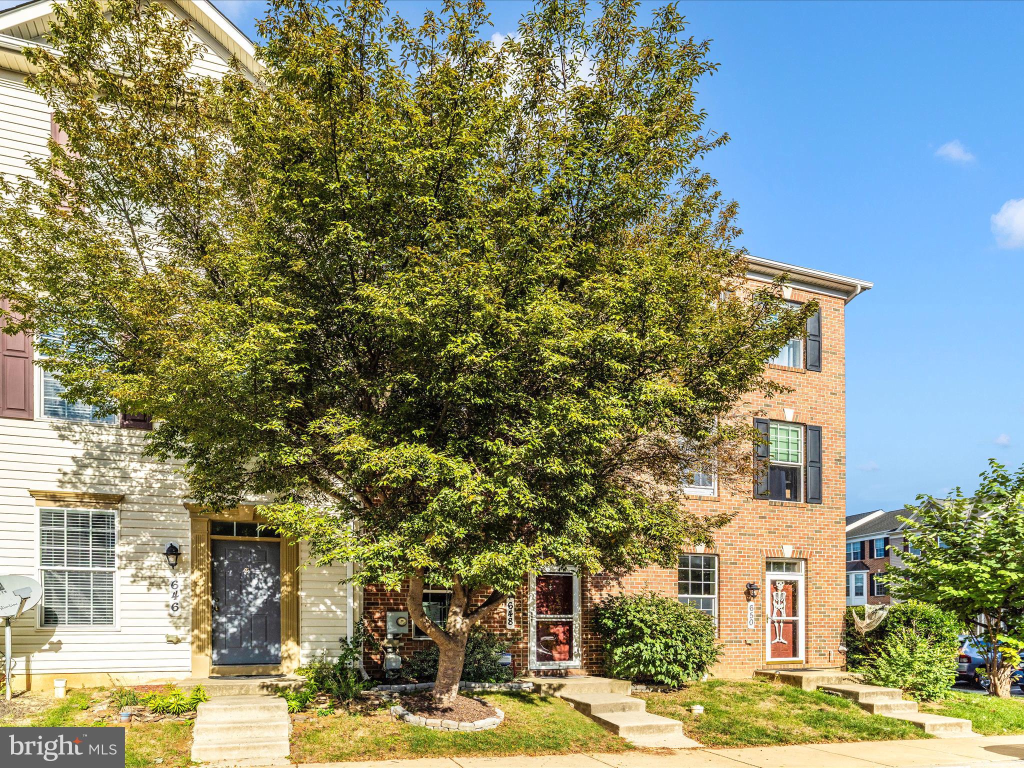 648 Tivoli Road Frederick, MD 21703 - Photo 41 of 51 a front view of a building with a tree