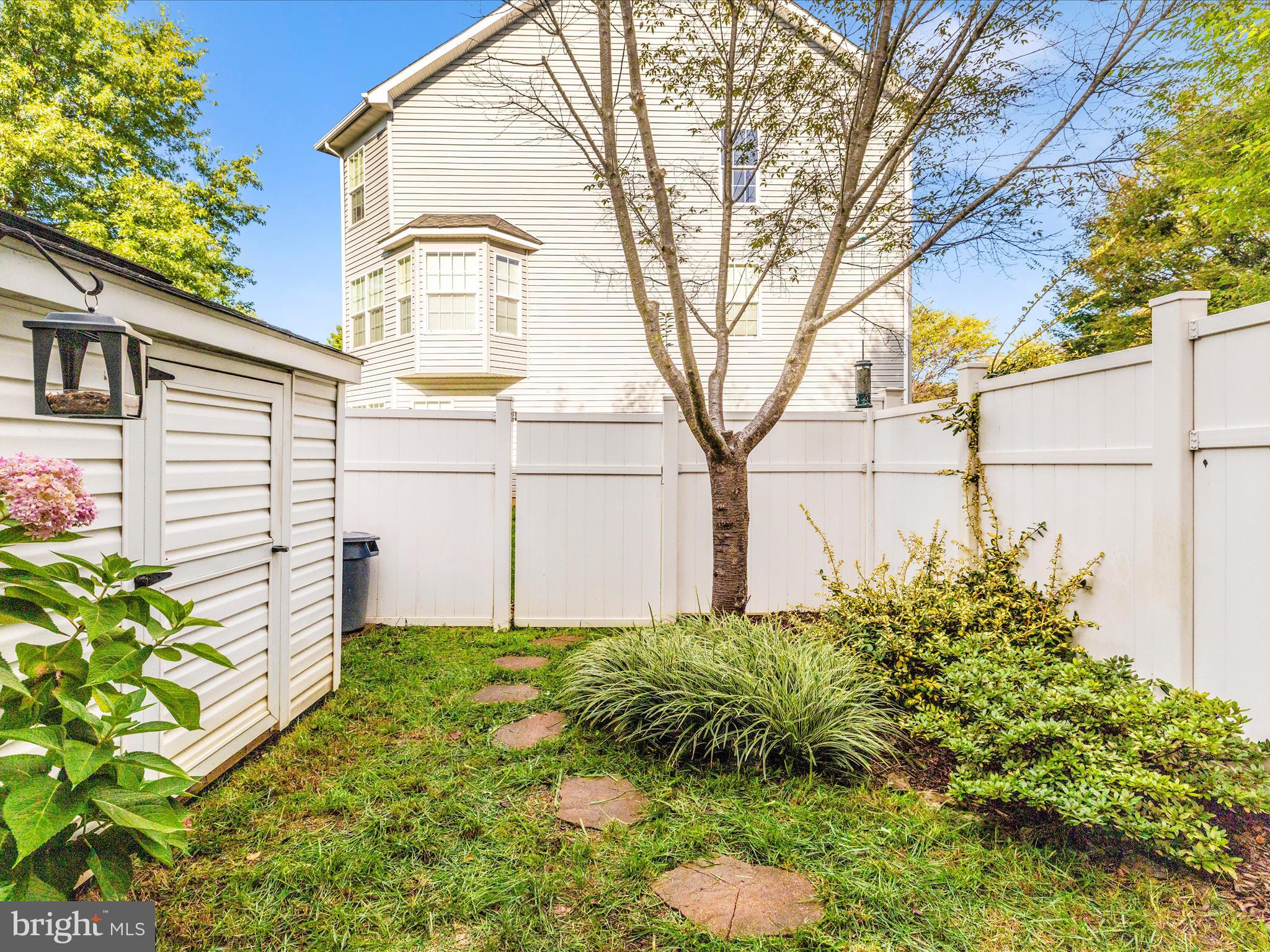 648 Tivoli Road Frederick, MD 21703 - Photo 46 of 51 a backyard of a white house with large tree