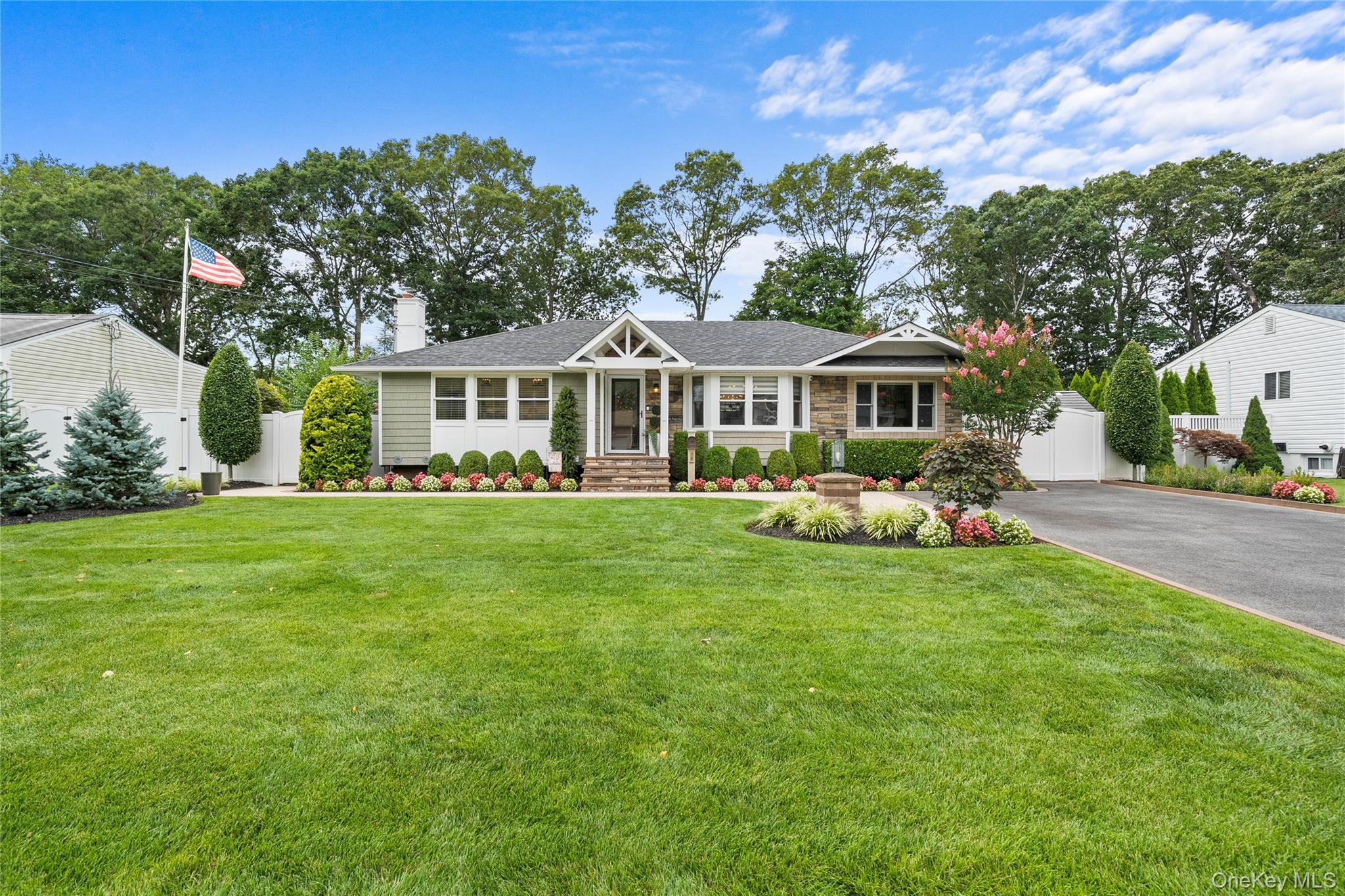 80 Otis Road Islip Terrace, NY 11752 - Photo 1 of 1 View of front facade with a chimney, a gate, asphalt driveway, stone siding, and a shingled roof