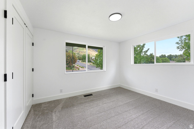 871 Bonita Way Centerville, UT 84014 - Photo 36 of 61 Bright interior space featuring white walls and a neutral-toned carpet