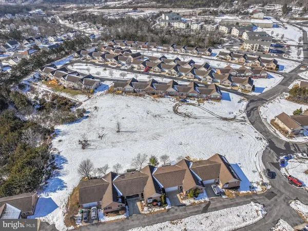 an aerial view of residential houses with outdoor space