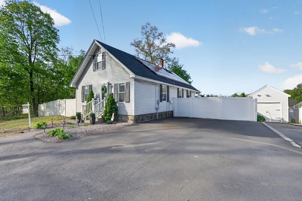 a view of a house with a street and garage