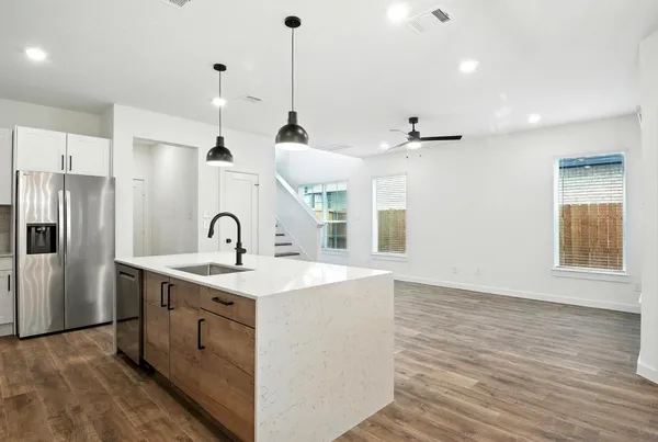 a kitchen with a sink a refrigerator and window