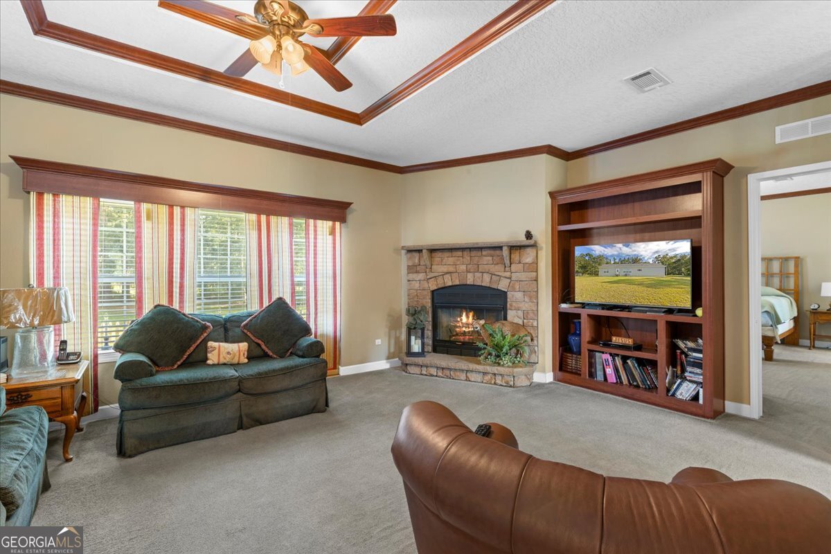 2273 Ga Highway 110 Folkston, GA 31537 - Photo 20 of 42 a living room with furniture flat screen tv and a fireplace