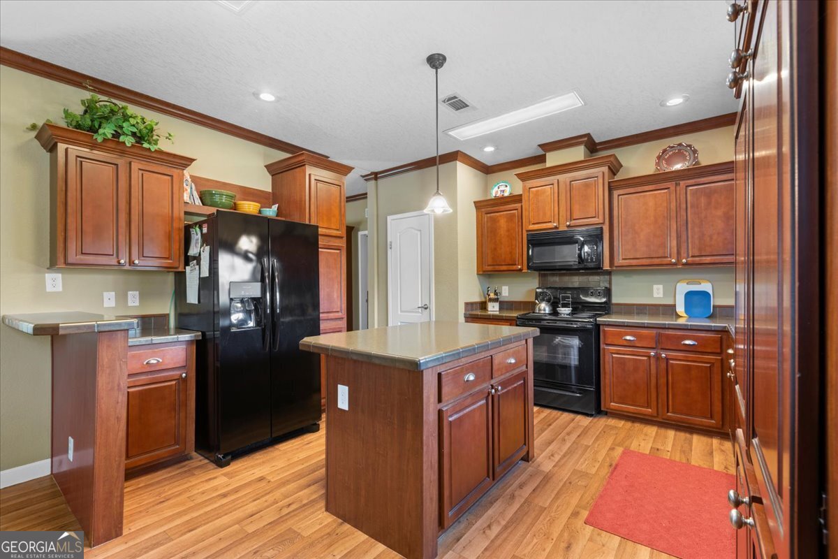 2273 Ga Highway 110 Folkston, GA 31537 - Photo 23 of 42 a kitchen with stainless steel appliances granite countertop a refrigerator a stove top oven a sink and dishwasher