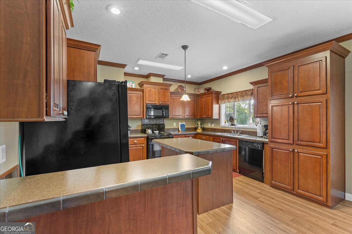 2273 Ga Highway 110 Folkston, GA 31537 - Photo 29 of 42 a kitchen with stainless steel appliances granite countertop a refrigerator a oven a sink counter space and wooden floor