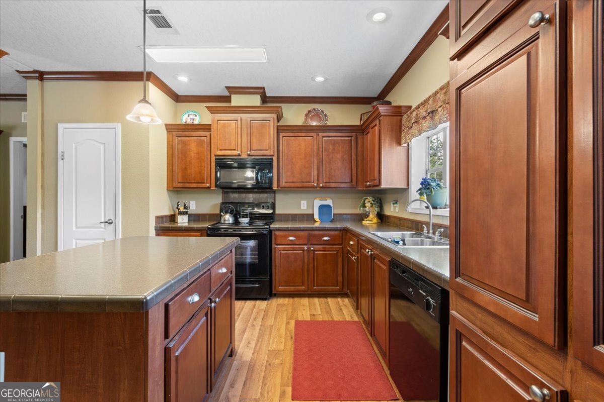 2273 Ga Highway 110 Folkston, GA 31537 - Photo 30 of 42 a kitchen with stainless steel appliances granite countertop a refrigerator a sink dishwasher a stove and white cabinets with wooden floor