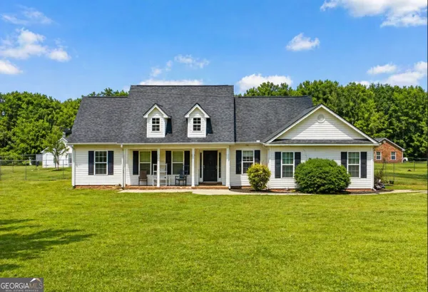 a front view of a house with a yard