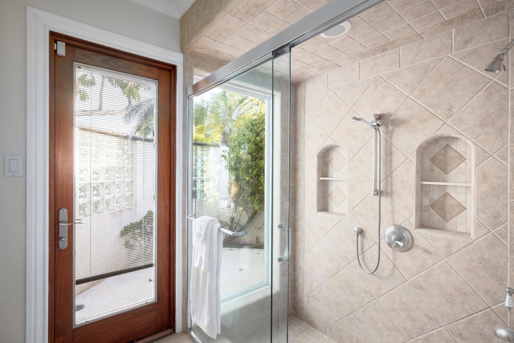 15017 Skyridge Road Poway, CA 92064 - Photo 26 of 54 a bathroom with a glass shower door and a window