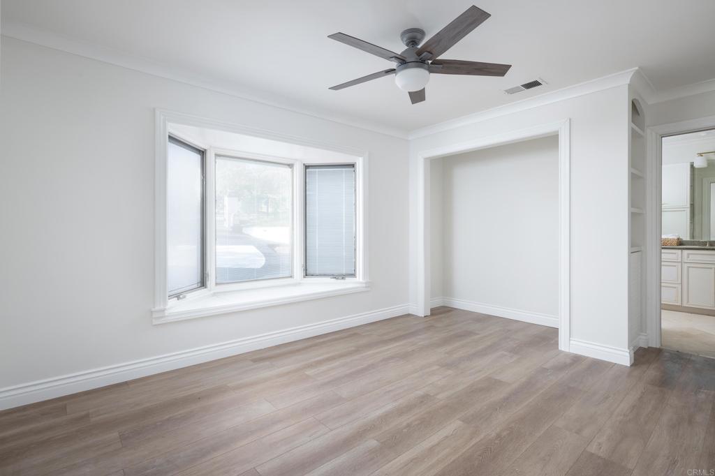 15017 Skyridge Road Poway, CA 92064 - Photo 27 of 54 a view of an empty room with wooden floor and a window