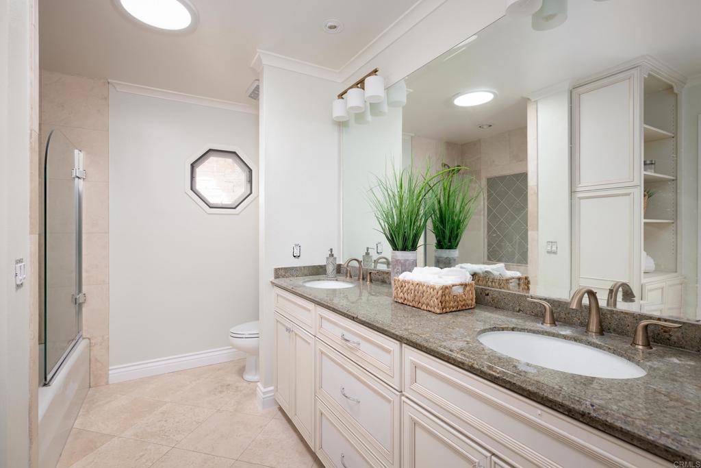 15017 Skyridge Road Poway, CA 92064 - Photo 28 of 54 a bathroom with a granite countertop sink mirror and a