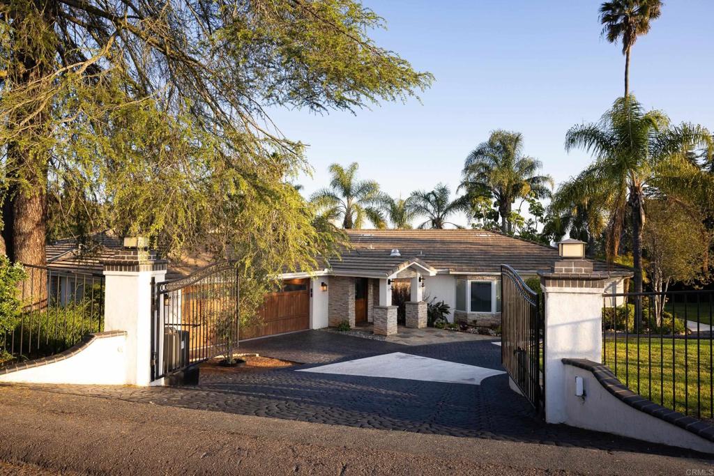 15017 Skyridge Road Poway, CA 92064 - Photo 3 of 54 a front view of a house with a garden