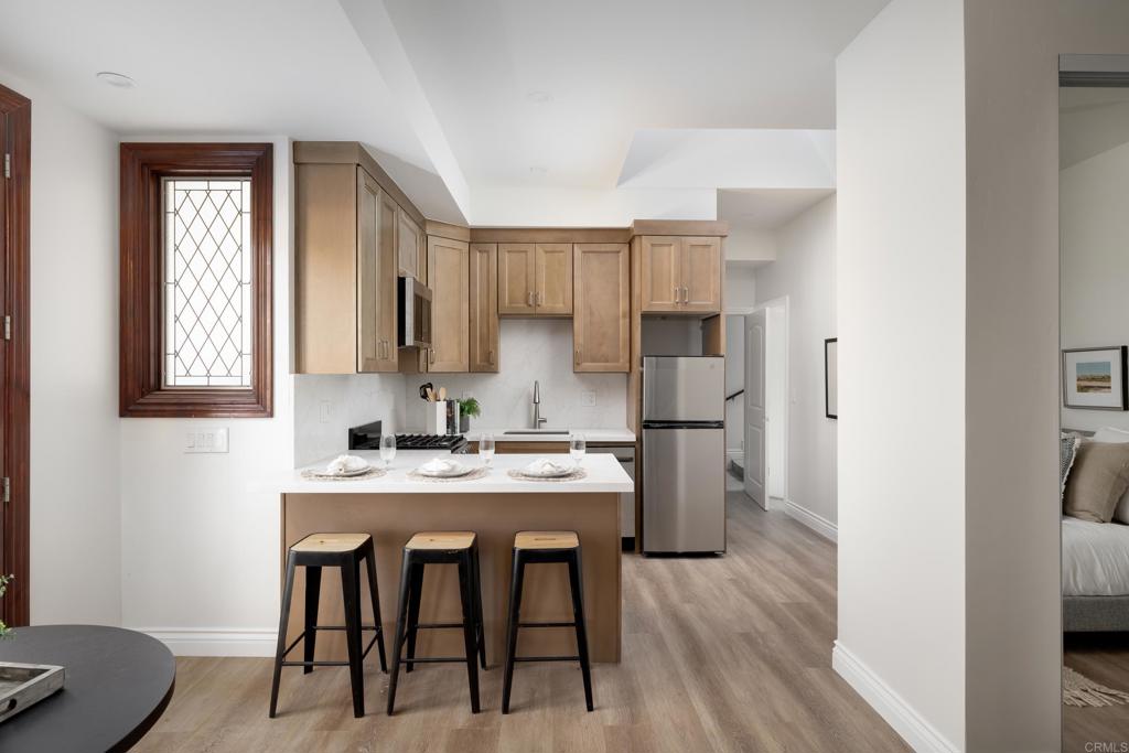 15017 Skyridge Road Poway, CA 92064 - Photo 31 of 54 a kitchen with a table chairs refrigerator and cabinets