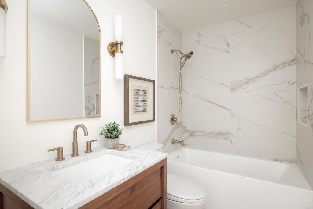 15017 Skyridge Road Poway, CA 92064 - Photo 33 of 54 a bathroom with a granite countertop tub sink and mirror