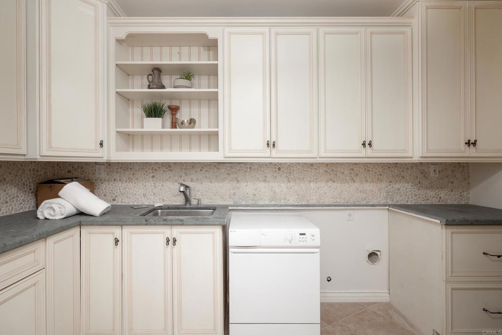 15017 Skyridge Road Poway, CA 92064 - Photo 34 of 54 a kitchen with stainless steel appliances granite countertop white cabinets and a sink