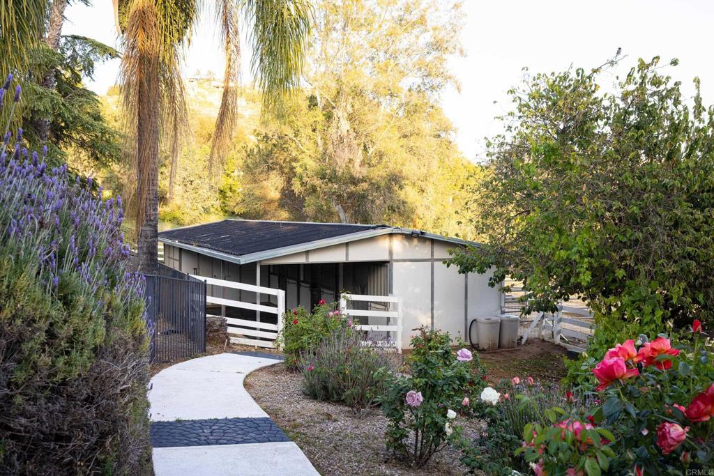 15017 Skyridge Road Poway, CA 92064 - Photo 43 of 54 a backyard of a house with flower plants and large trees