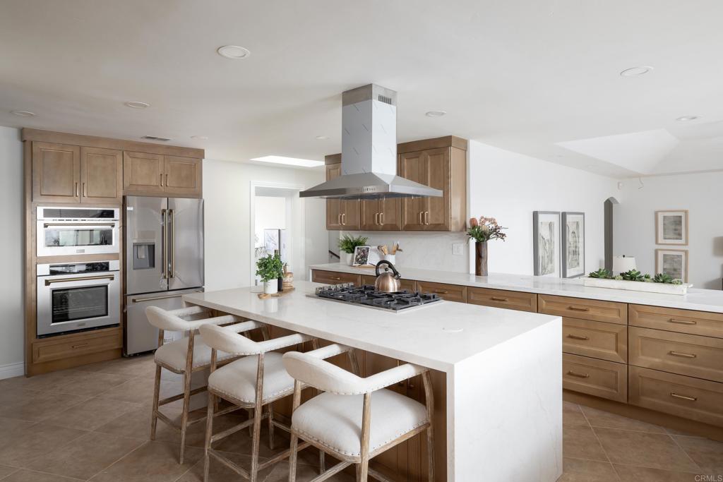 15017 Skyridge Road Poway, CA 92064 - Photo 6 of 54 a kitchen with kitchen island a sink stove and refrigerator