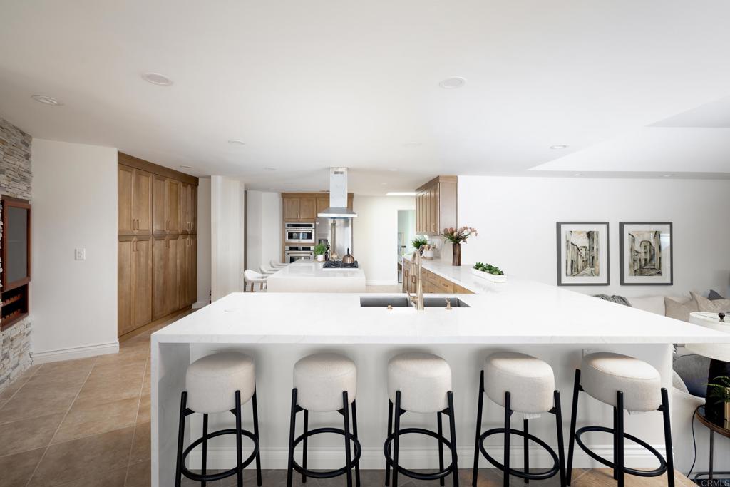 15017 Skyridge Road Poway, CA 92064 - Photo 7 of 54 a dining hall with stainless steel appliances kitchen island a table and chairs