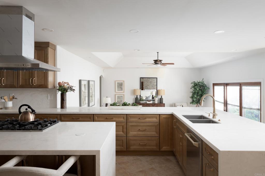 15017 Skyridge Road Poway, CA 92064 - Photo 10 of 54 a kitchen with a sink a stove and cabinets