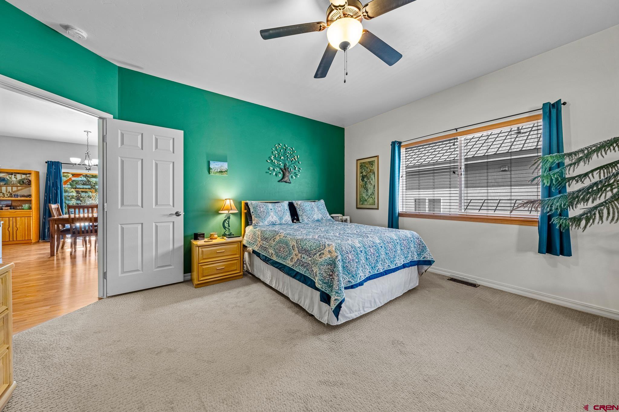 72 Cedar Ridge Way Durango, CO 81301 - Photo 12 of 33 a bedroom with a large bed and a chandelier