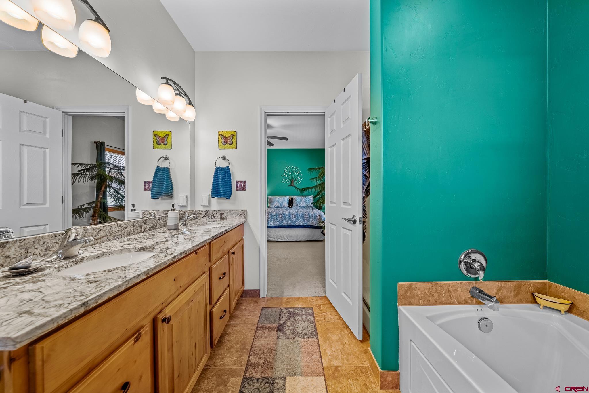 72 Cedar Ridge Way Durango, CO 81301 - Photo 14 of 33 a bathroom with a granite countertop sink and a mirror
