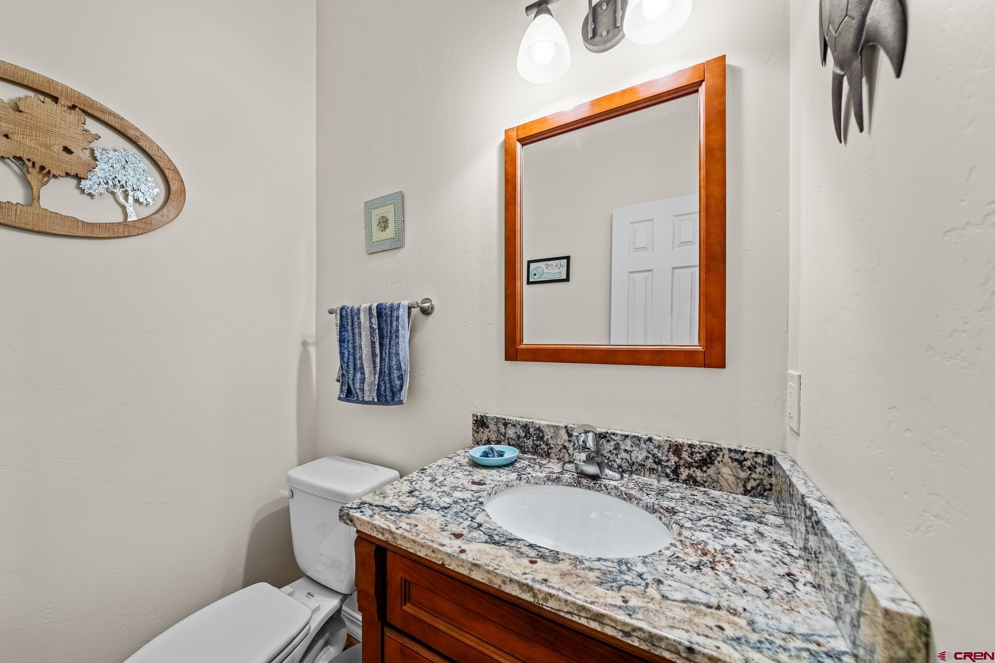 72 Cedar Ridge Way Durango, CO 81301 - Photo 24 of 33 a bathroom with a granite countertop sink and a mirror