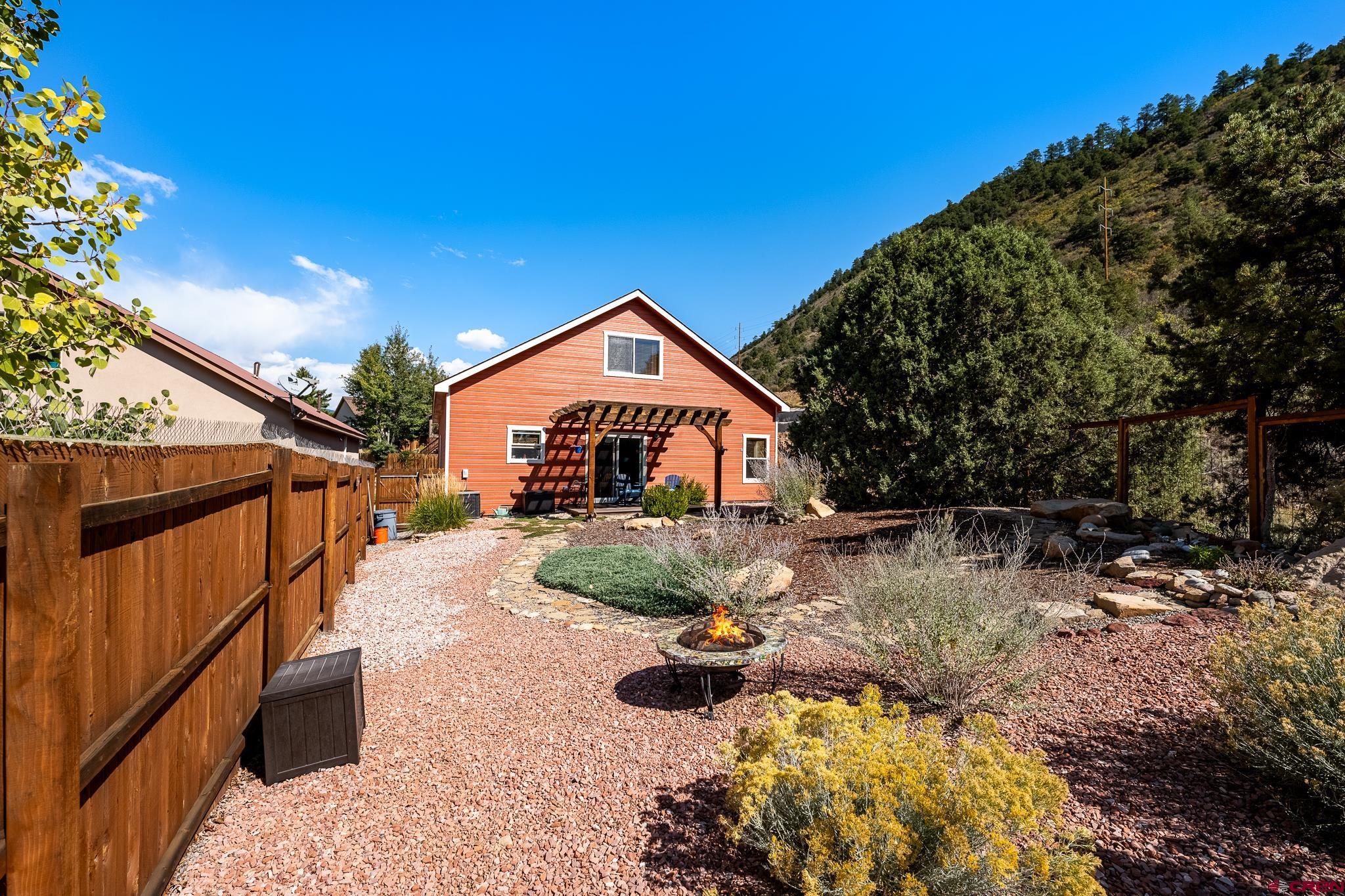 72 Cedar Ridge Way Durango, CO 81301 - Photo 30 of 33 a front view of a house with garden