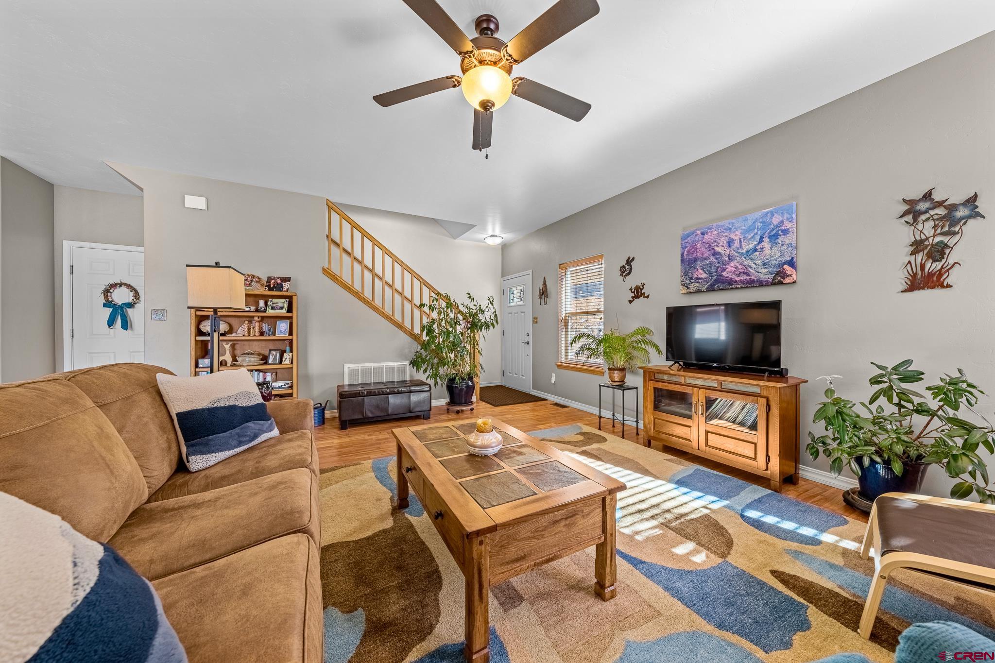 72 Cedar Ridge Way Durango, CO 81301 - Photo 4 of 33 a living room with furniture a flat screen tv and a table