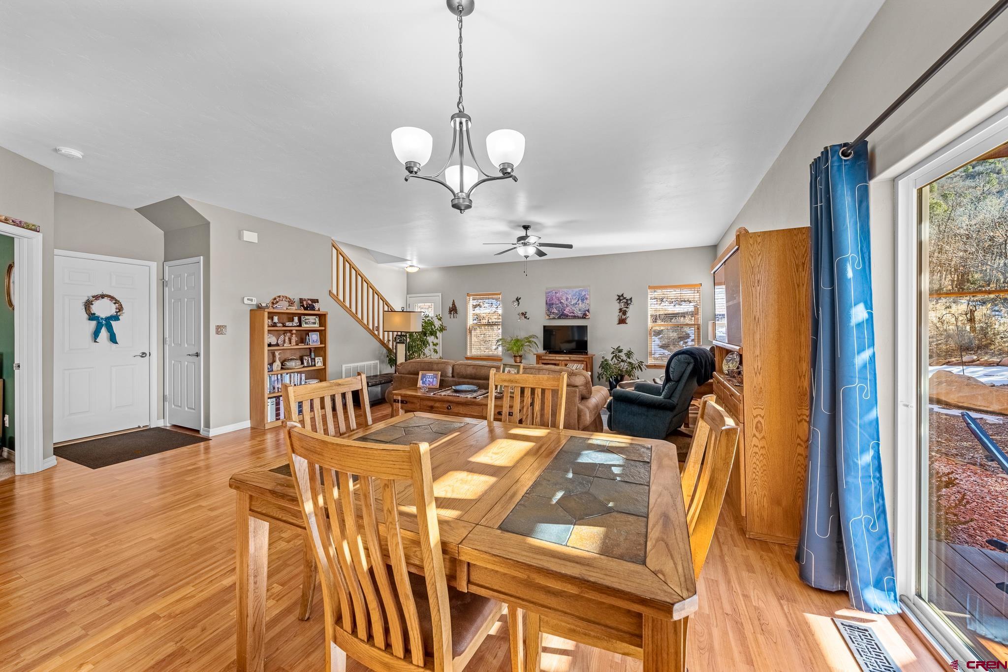 72 Cedar Ridge Way Durango, CO 81301 - Photo 5 of 33 a view of a dining room with furniture a chandelier and wooden floor