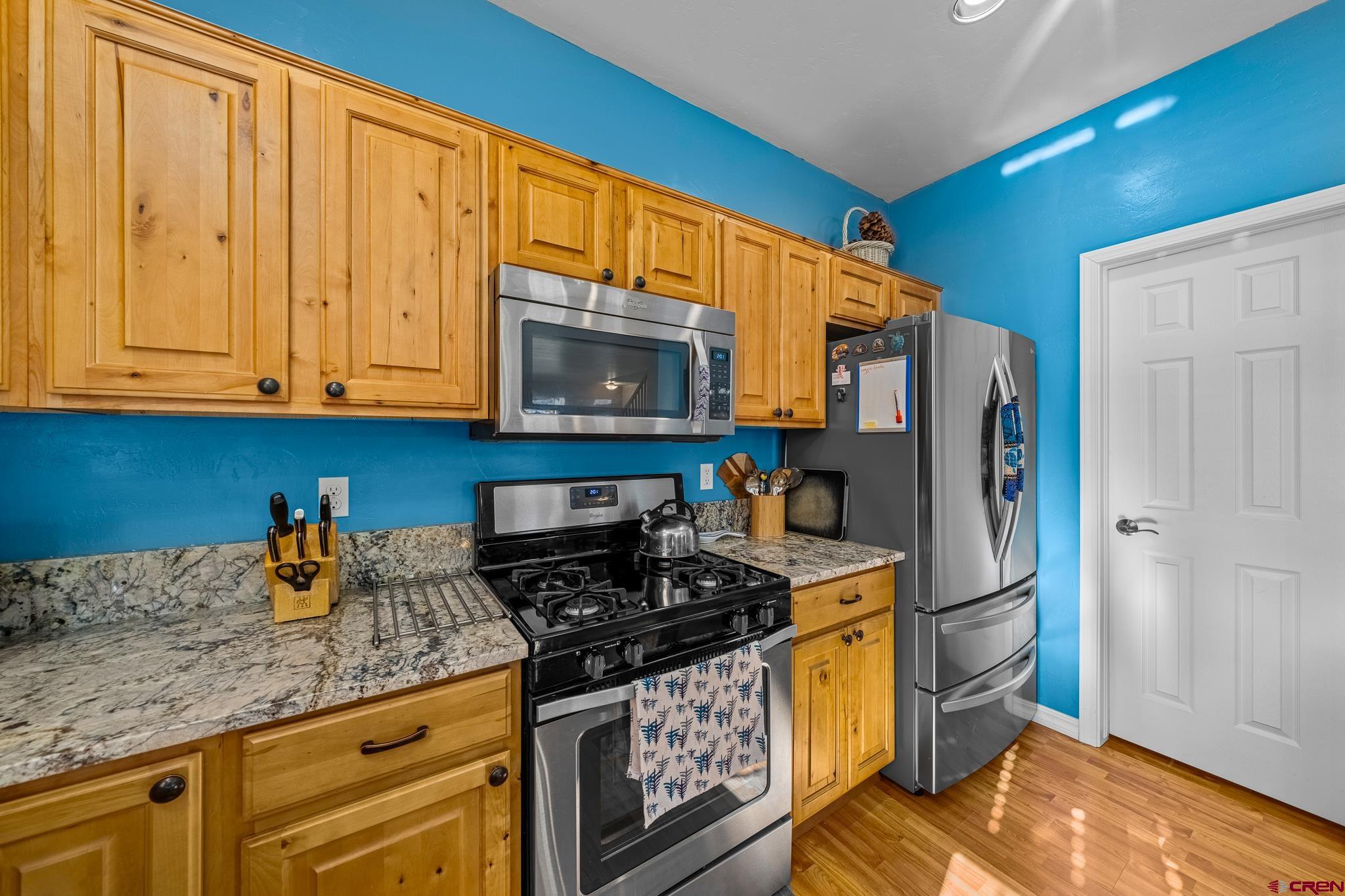 72 Cedar Ridge Way Durango, CO 81301 - Photo 8 of 33 a kitchen with stainless steel appliances granite countertop a refrigerator stove and sink