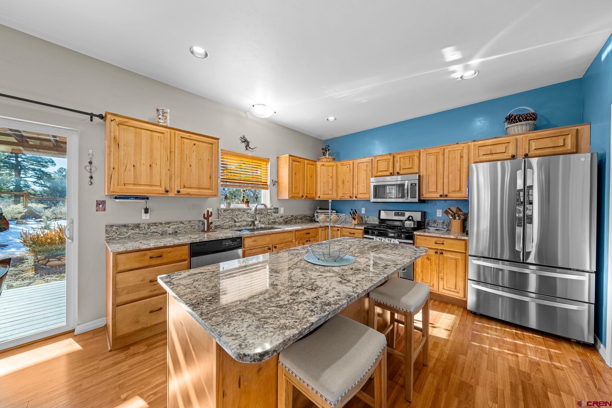 72 Cedar Ridge Way Durango, CO 81301 - Photo 9 of 33 a kitchen with stainless steel appliances granite countertop a refrigerator a stove top oven and a sink