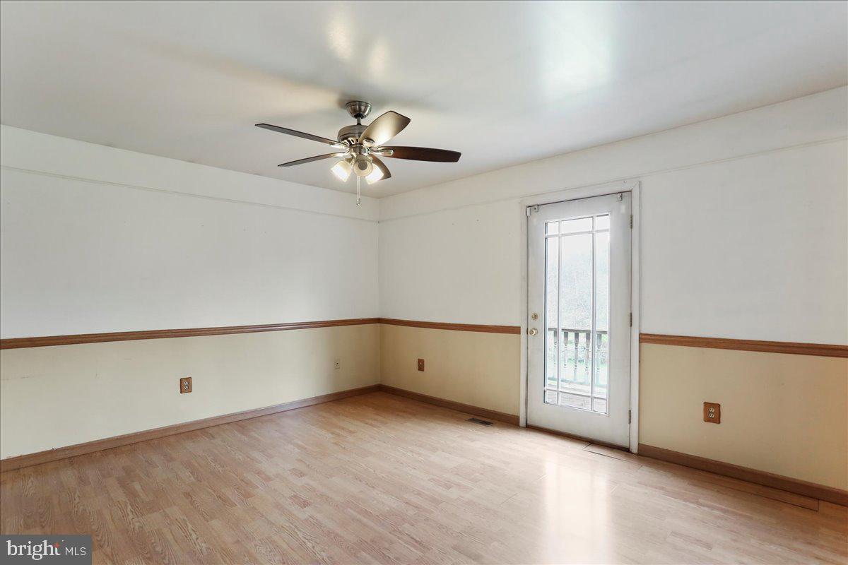 4045 North Stone Road Taneytown, MD 21787 - Photo 14 of 45 an empty room with chandelier fan