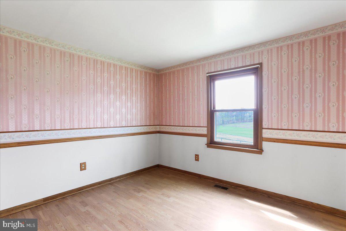 4045 North Stone Road Taneytown, MD 21787 - Photo 17 of 45 a room with a window and a wooden floor