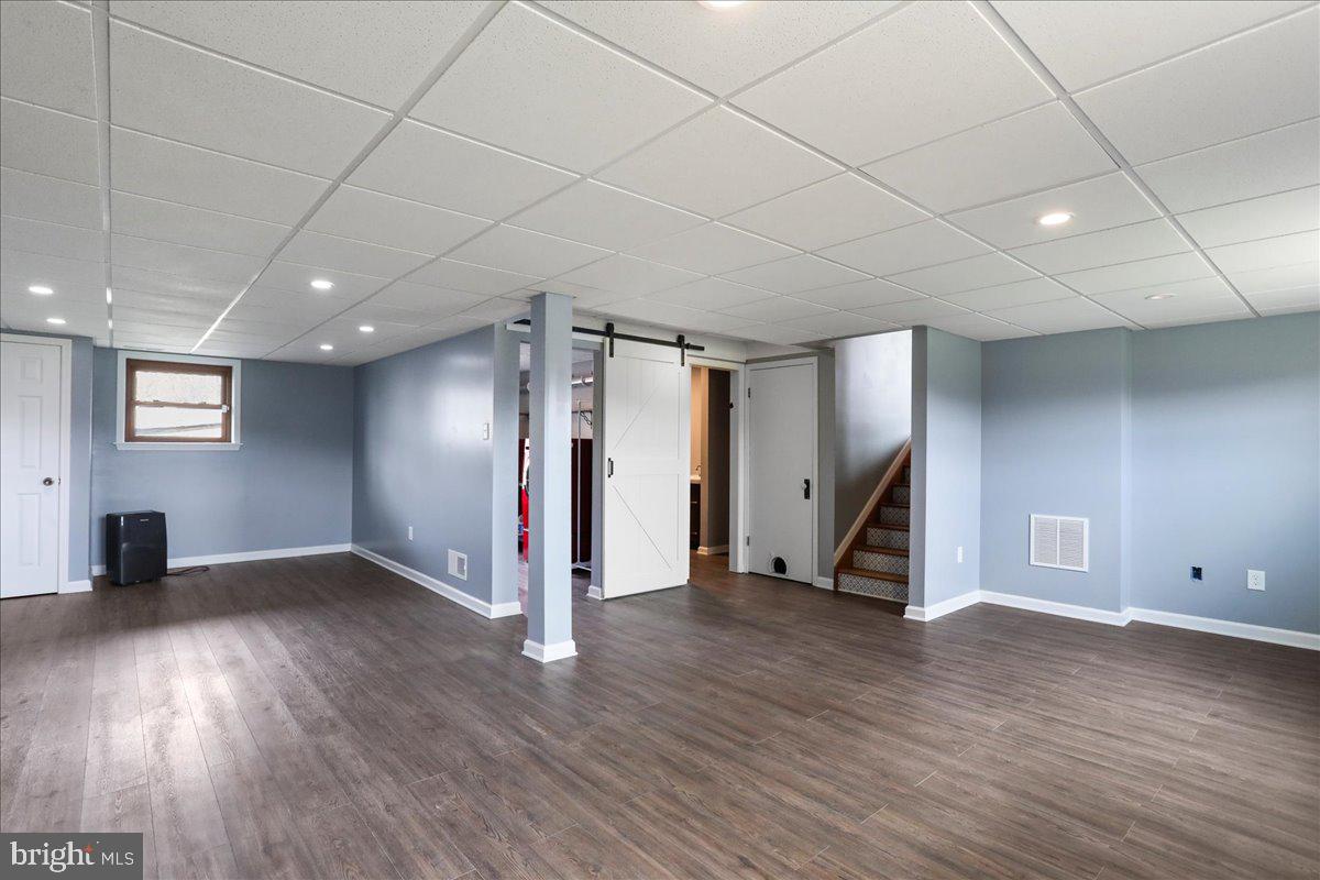 4045 North Stone Road Taneytown, MD 21787 - Photo 23 of 45 an empty room with wooden floor and stairs