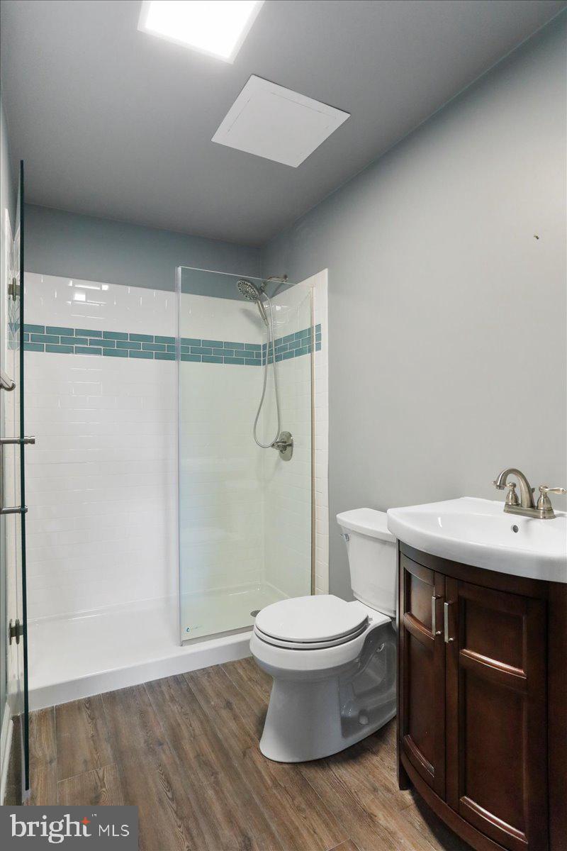4045 North Stone Road Taneytown, MD 21787 - Photo 26 of 45 a bathroom with a sink a toilet a shower and a mirror