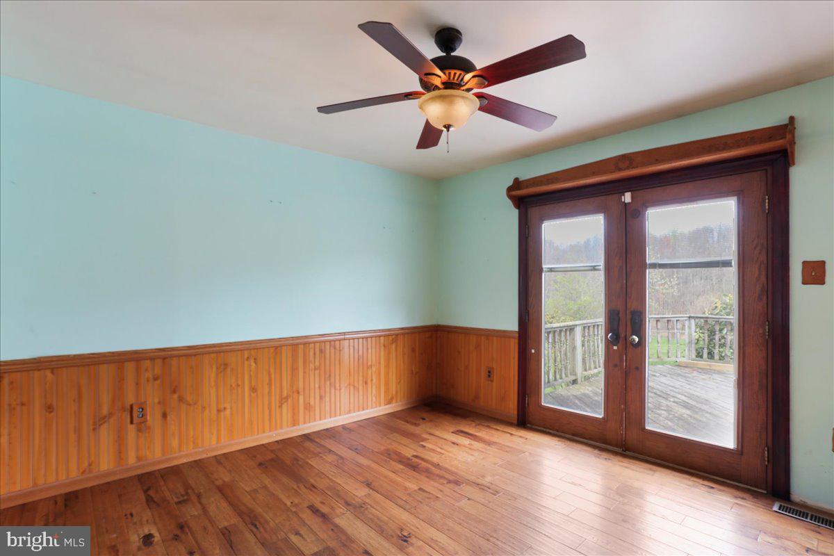 4045 North Stone Road Taneytown, MD 21787 - Photo 8 of 45 an empty room with wooden floor and windows