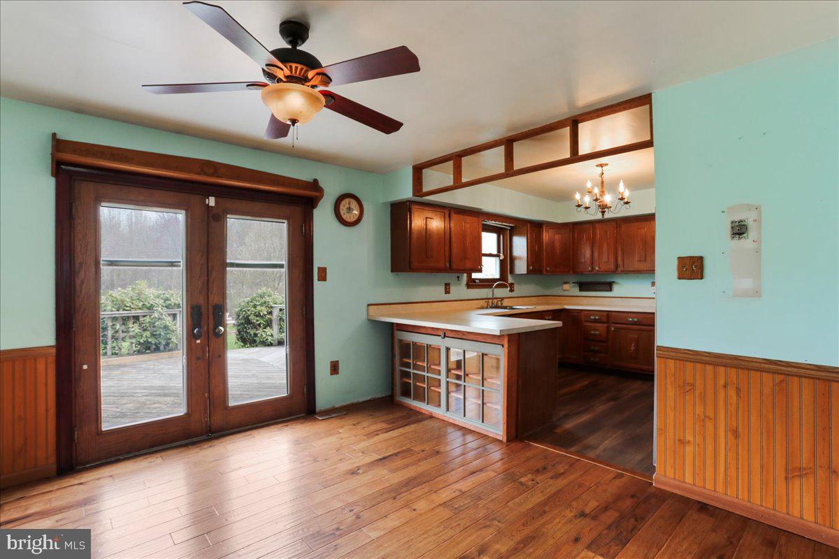4045 North Stone Road Taneytown, MD 21787 - Photo 9 of 45 a kitchen with stainless steel appliances granite countertop a sink a stove and a wooden floors
