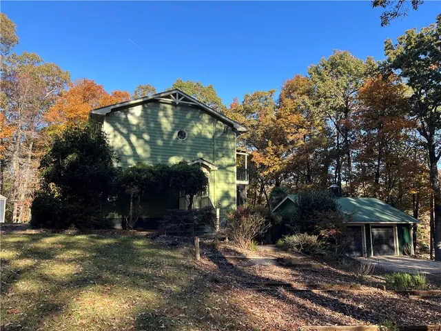 a view of a livingroom with wooden floor and a chandelier