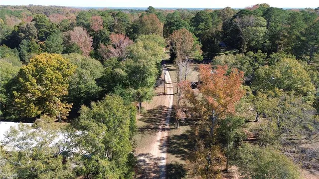 an aerial view of a house with outdoor space pool seating area and yard