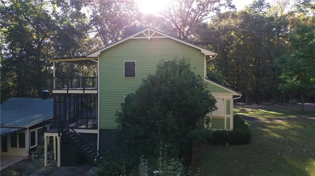a view of a house with large windows and a small yard